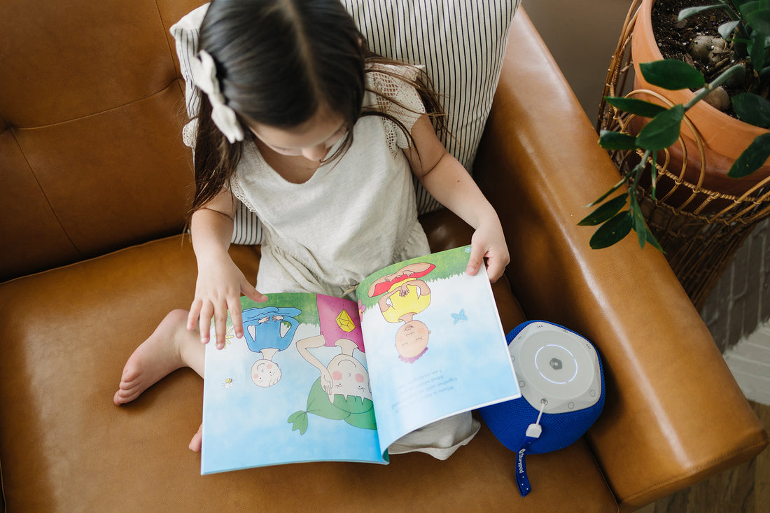 Toddler enjoying a read-along audiobook with her Storypod