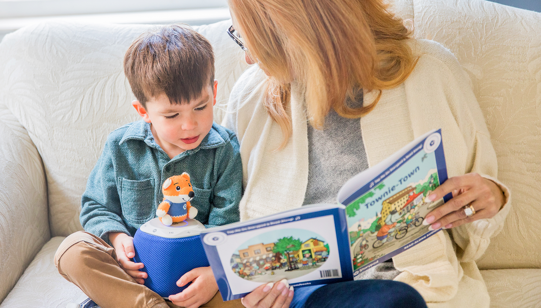 A child reading along with the Storypod.
