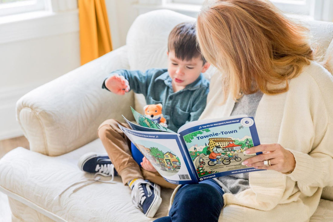Mother and son sit on couch while reading a book. You can strengthen your child's literacy skills by using their favorite books.