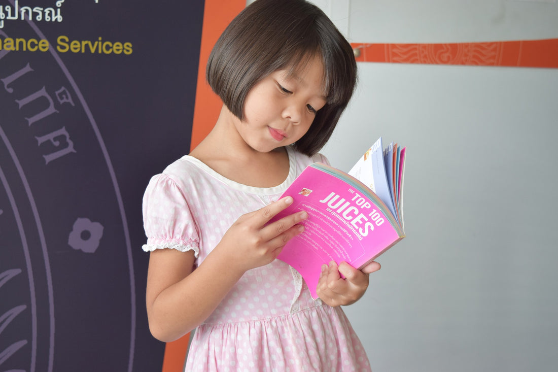 Child practicing sight words while reading book