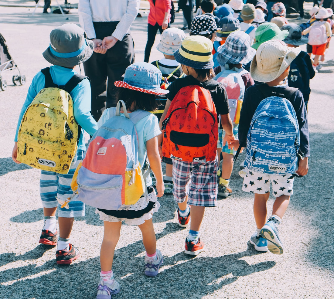 A group of kindergarteners walk to school together with their backpacks on. Kindergarten is an important time to develop your child's social skills as their time at school will depend greatly on how well their interactions with others go.