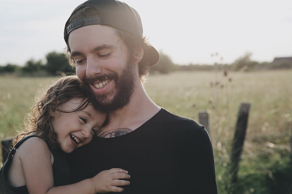 6-year-old daughter and her father hug, both with big smiles on their faces. There are several ways to fill your child's emotional bucket to ensure that they are growing up healthy and happy.