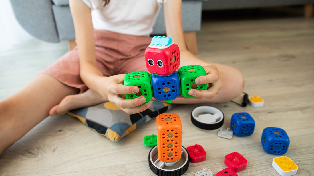 Child engages in STEM education by playing with blocks and tools on the floor