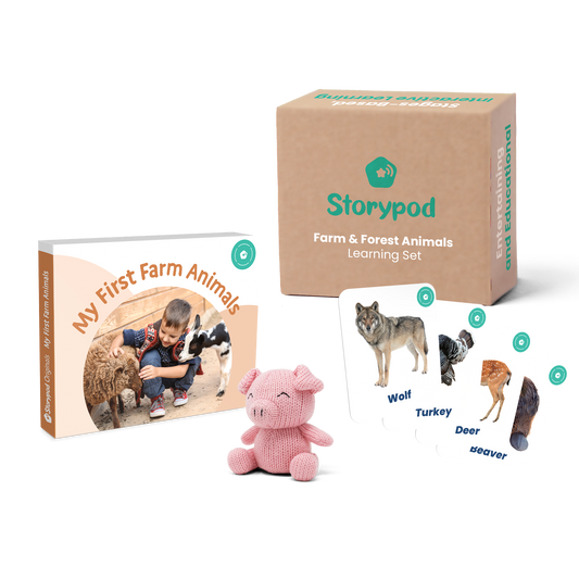 Storypod learning set with animal cards, box, and pink pig plush toy.
